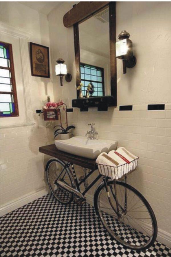 An old bicycle used as bathroom furniture